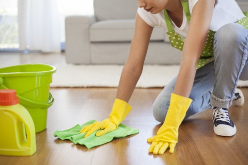 Cleaner mopping a shared corridor in a residential property